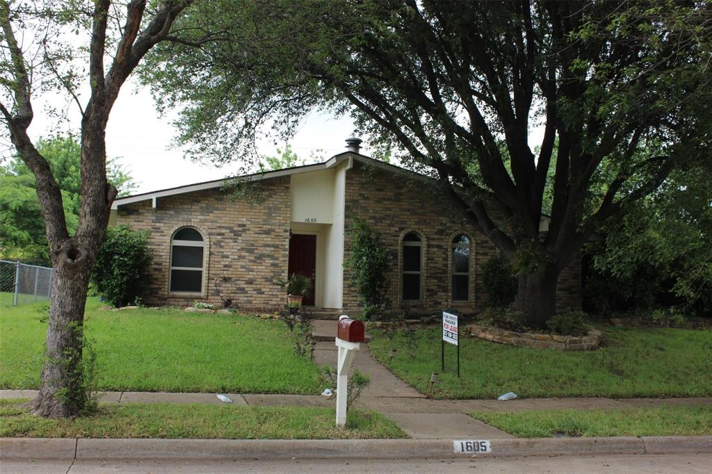 1605 Spanish Trail Plano, TX 75023 - Photo 1 of 5 a front view of a house with a yard