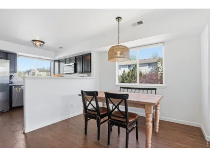 a dining room with furniture and window