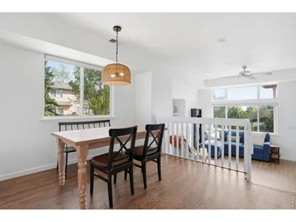 a dining room with furniture window and wooden floor