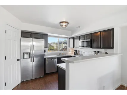 a kitchen with stainless steel appliances a sink stove and refrigerator