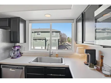 a kitchen with a sink and a window