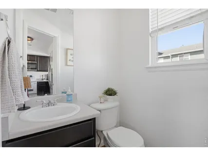 a bathroom with a sink toilet and mirror