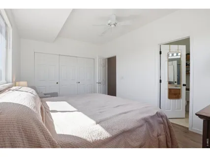 a bedroom with a bed and a mirror