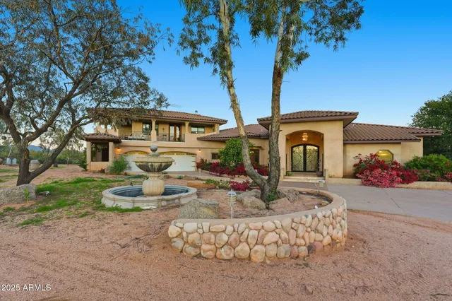 a spacious bedroom with a bed and a flat screen tv