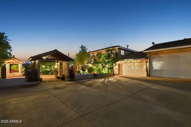 a en suite bathroom with a granite countertop double vanity sink and a mirror