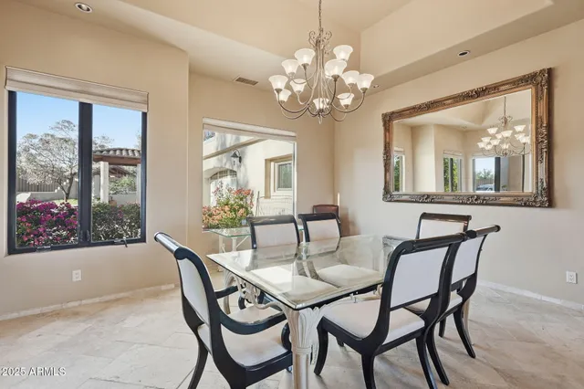 a view of a chairs and table in the balcony