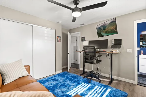 a bedroom with furniture and a wooden floor