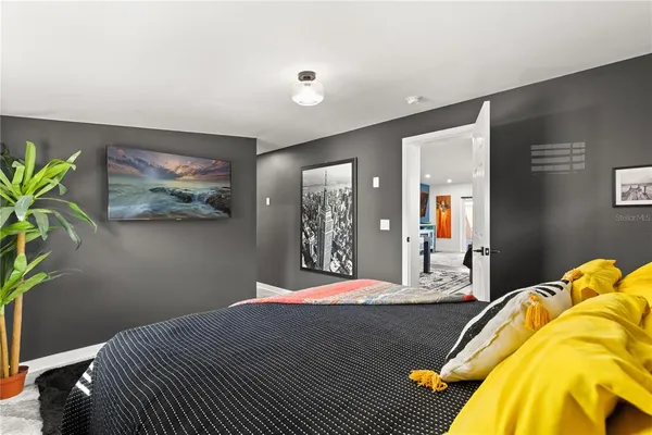 a bedroom with a bed and a lamp