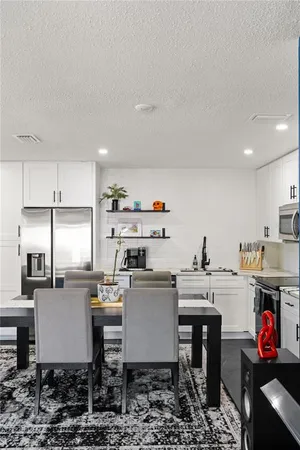 a kitchen with a table chairs stove and cabinets