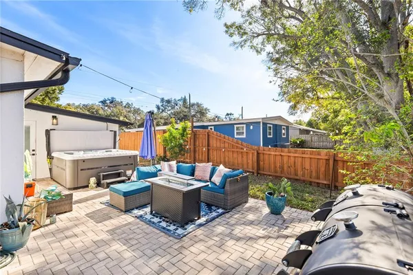 a view of a patio with couches chairs and a fire pit