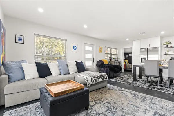 a living room with furniture and wooden floor