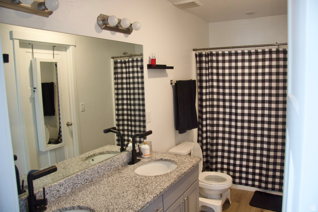 327 West Main Street, Unit 14 Santaquin, UT 84655 - Photo 11 of 20 Full bathroom featuring double vanity, a shower with shower curtain, and light wood-style flooring