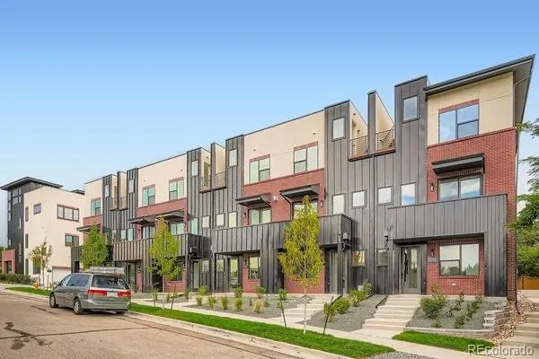 a city street lined with buildings and cars parked in front of it