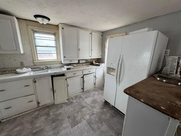 a kitchen with a sink stove and refrigerator