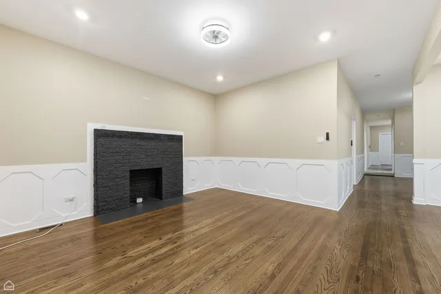 a view of an empty room and wooden floor