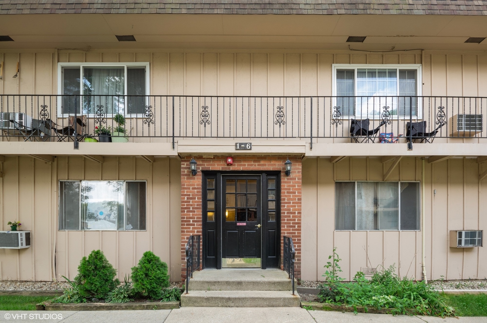 2300 West Algonquin Road, Unit 6 Rolling Meadows, IL 60008 - Photo 2 of 17 a front view of a house with many windows