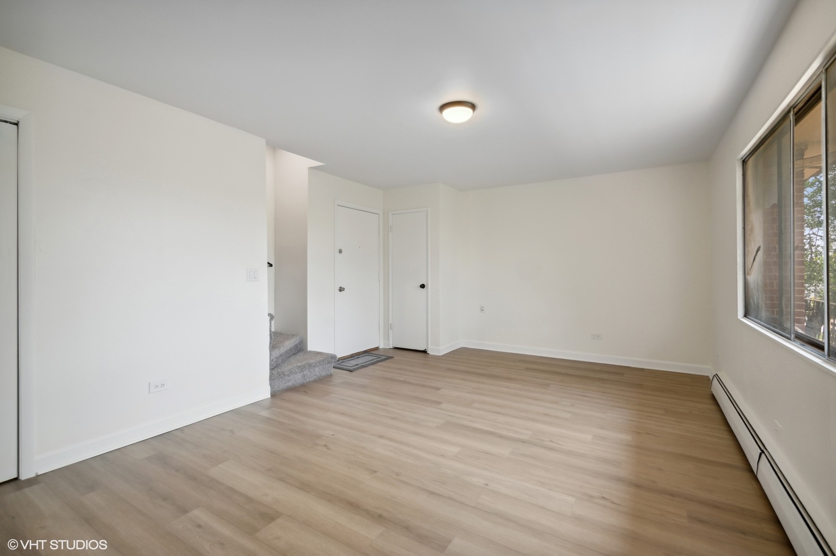 2300 West Algonquin Road, Unit 6 Rolling Meadows, IL 60008 - Photo 5 of 17 an empty room with wooden floor and windows