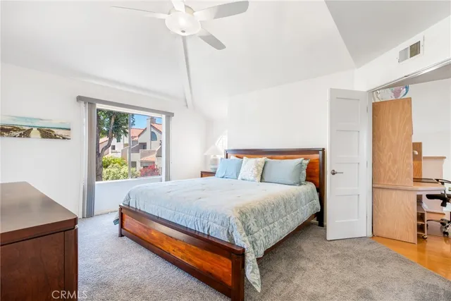 a bedroom with a bed and glass walk in closet