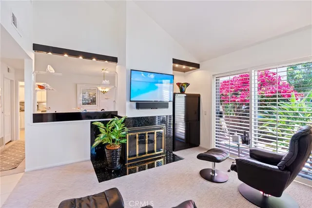 a living room with furniture fireplace and flat screen tv