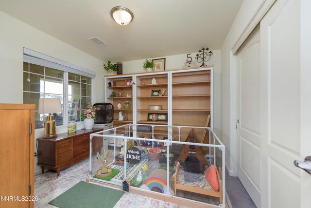 a room with furniture a rug and a window