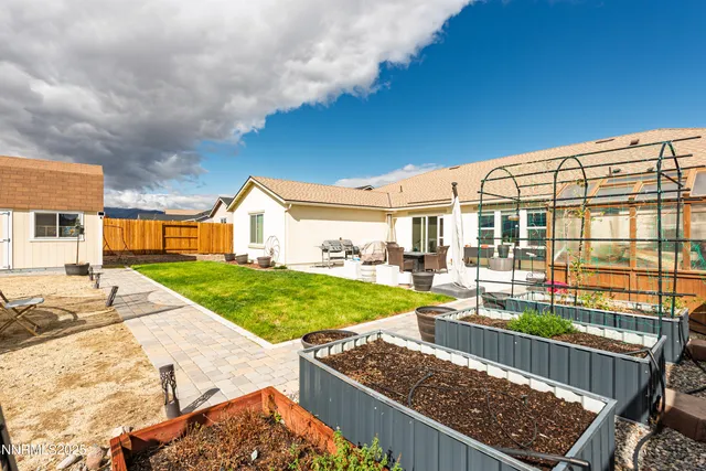 a view of an house with backyard and patio