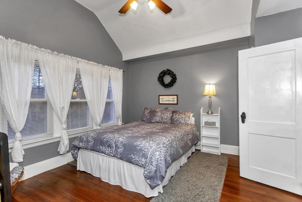231 Wheatland Avenue Chicopee, MA 01020 - Photo 19 of 36 a bedroom with a bed and a lamp with wooden floor