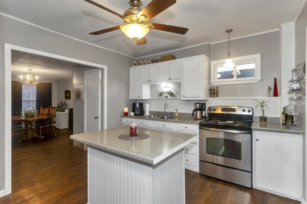 231 Wheatland Avenue Chicopee, MA 01020 - Photo 2 of 36 a kitchen with a stove cabinets and wooden floor