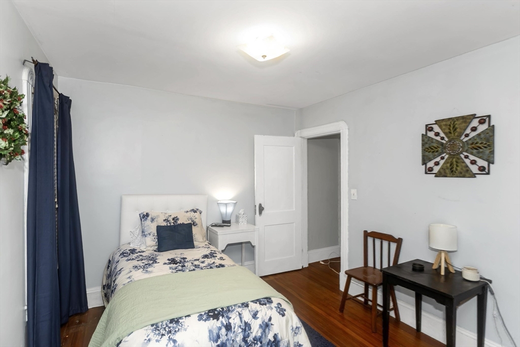 231 Wheatland Avenue Chicopee, MA 01020 - Photo 24 of 36 a bedroom with a bed and a table in it