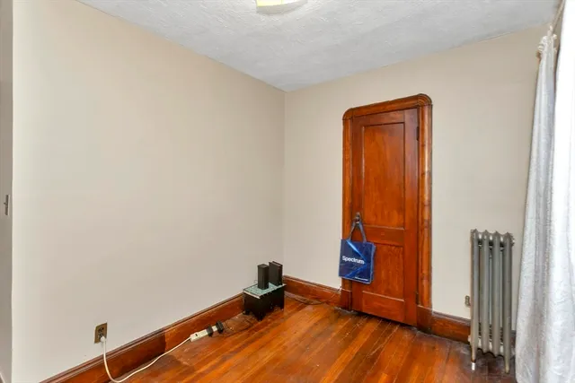an empty room with wooden floor and closet
