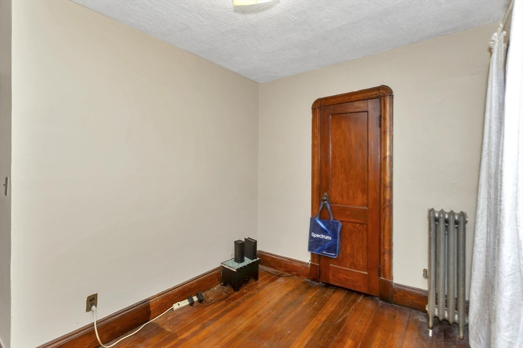 231 Wheatland Avenue Chicopee, MA 01020 - Photo 25 of 36 an empty room with wooden floor and closet