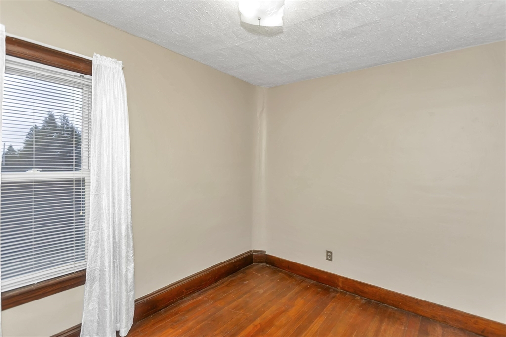 231 Wheatland Avenue Chicopee, MA 01020 - Photo 26 of 36 a view of a room with wooden floor and a window