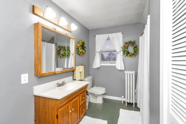 a bathroom with a sink toilet and mirror