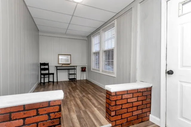 a room with pool table and windows