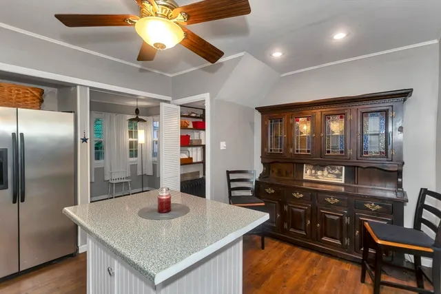 a kitchen with stainless steel appliances granite countertop a sink a stove and a refrigerator