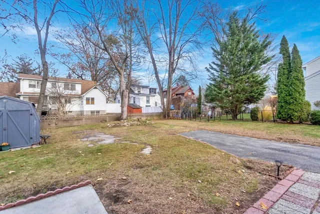 a view of yard with swimming pool and trees