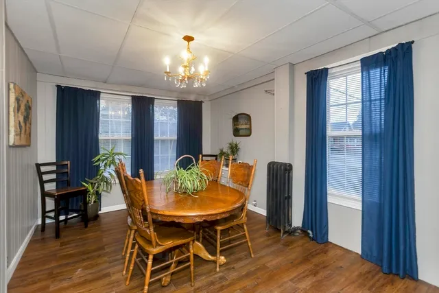 a view of a dining room with furniture and chandelier