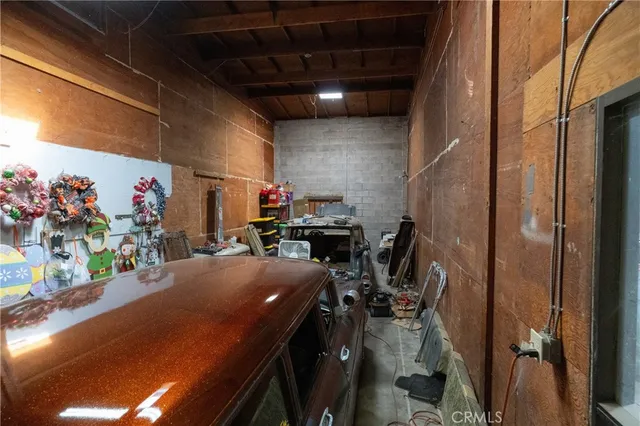 a bedroom with bed and a car parked