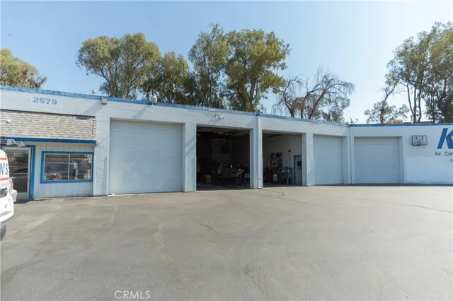 front view of a house with a yard and trees