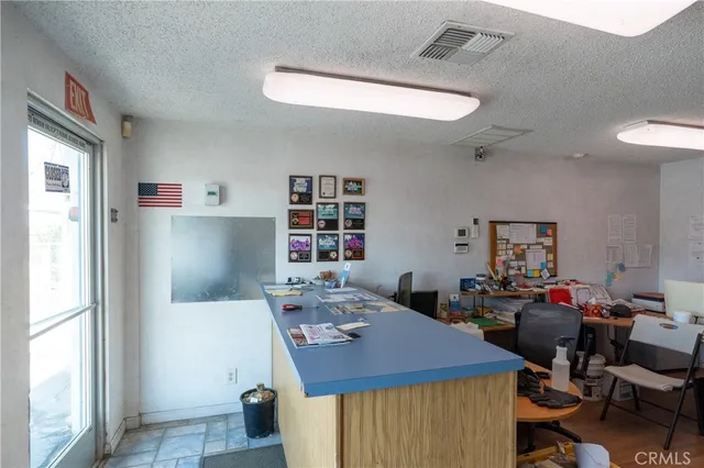 a living room with furniture a wooden floor and next to a window