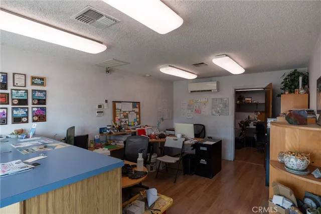 a view of a workspace with furniture and window