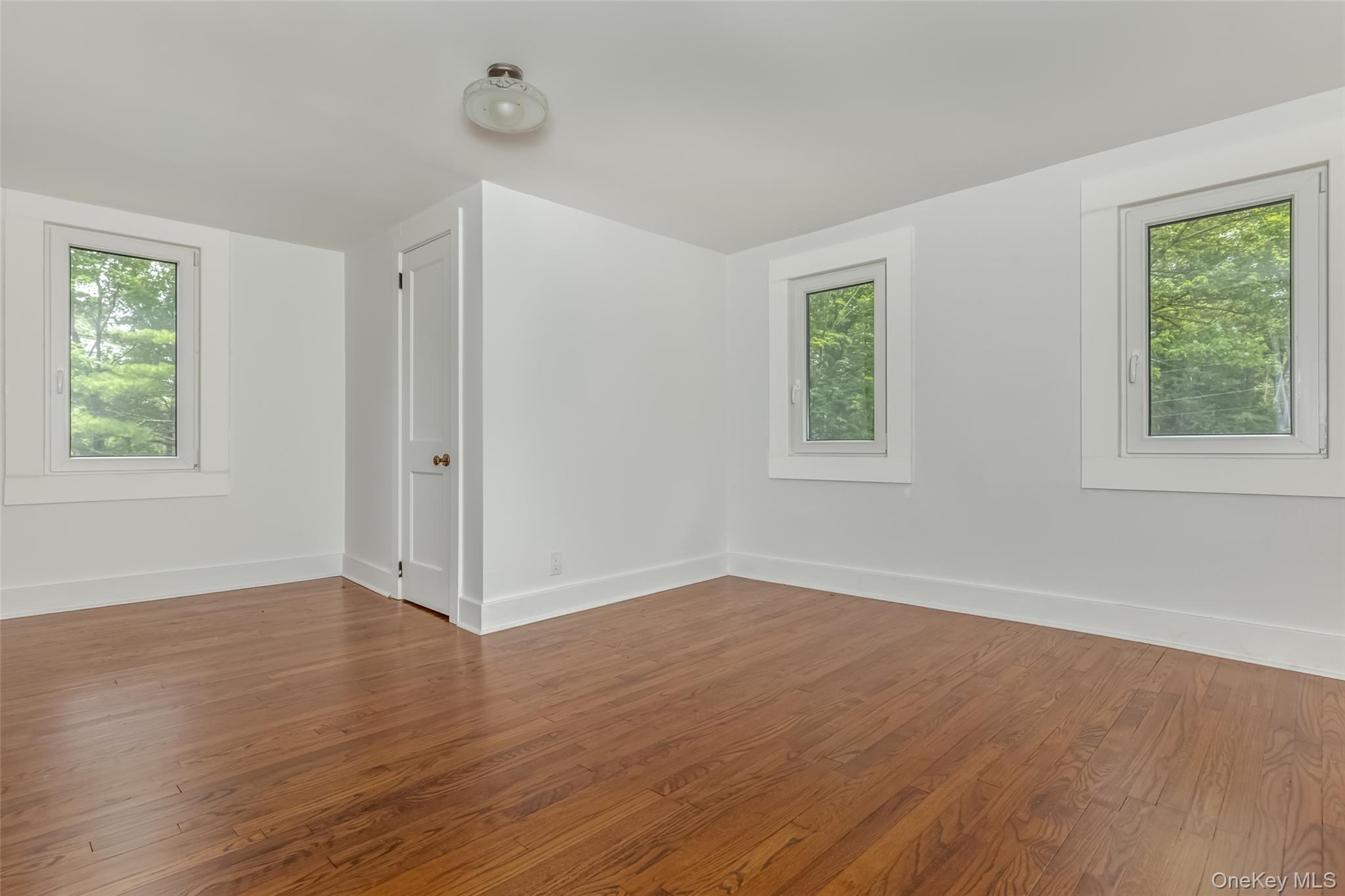 405 Vista Maria Road Cragsmoor, NY 12566 - Photo 28 of 35 an empty room with wooden floor and windows