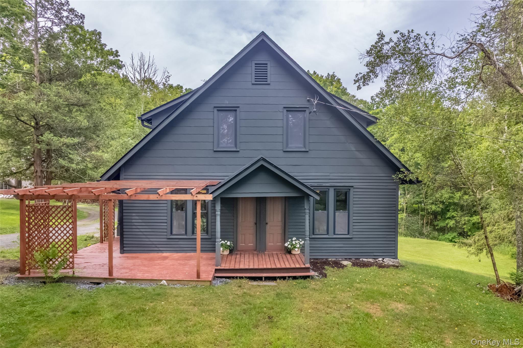 405 Vista Maria Road Cragsmoor, NY 12566 - Photo 4 of 35 a front view of a house with a yard