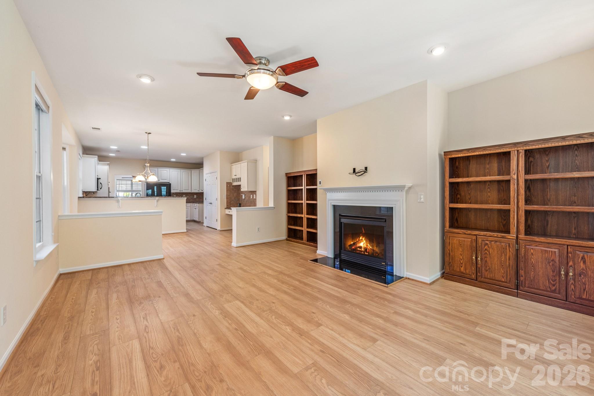 2013 Citron Avenue Fort Mill, SC 29708 - Photo 14 of 34 a view of a livingroom with a fireplace a ceiling fan and windows