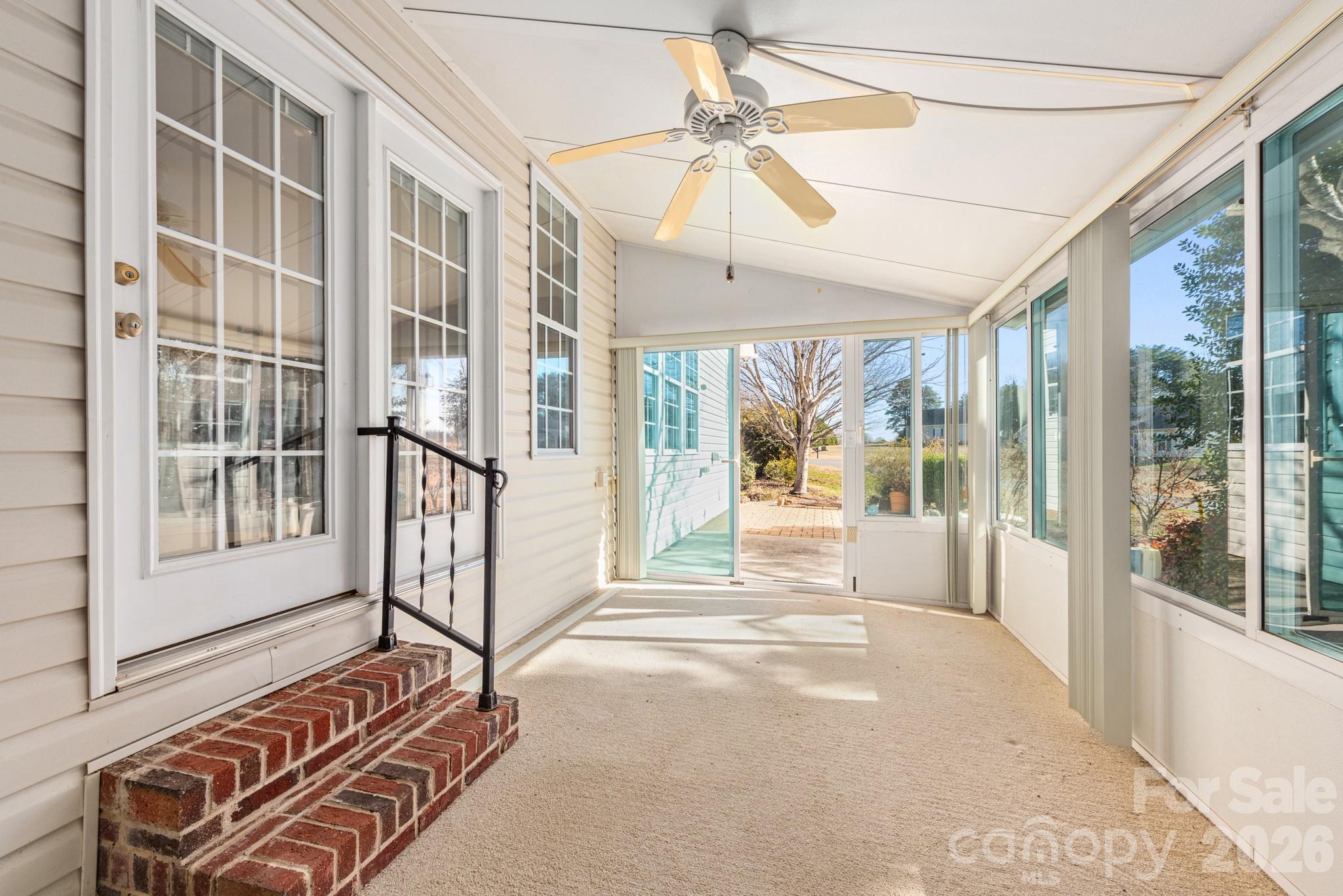 2013 Citron Avenue Fort Mill, SC 29708 - Photo 30 of 34 a living room with a balcony a ceiling fan and a rug