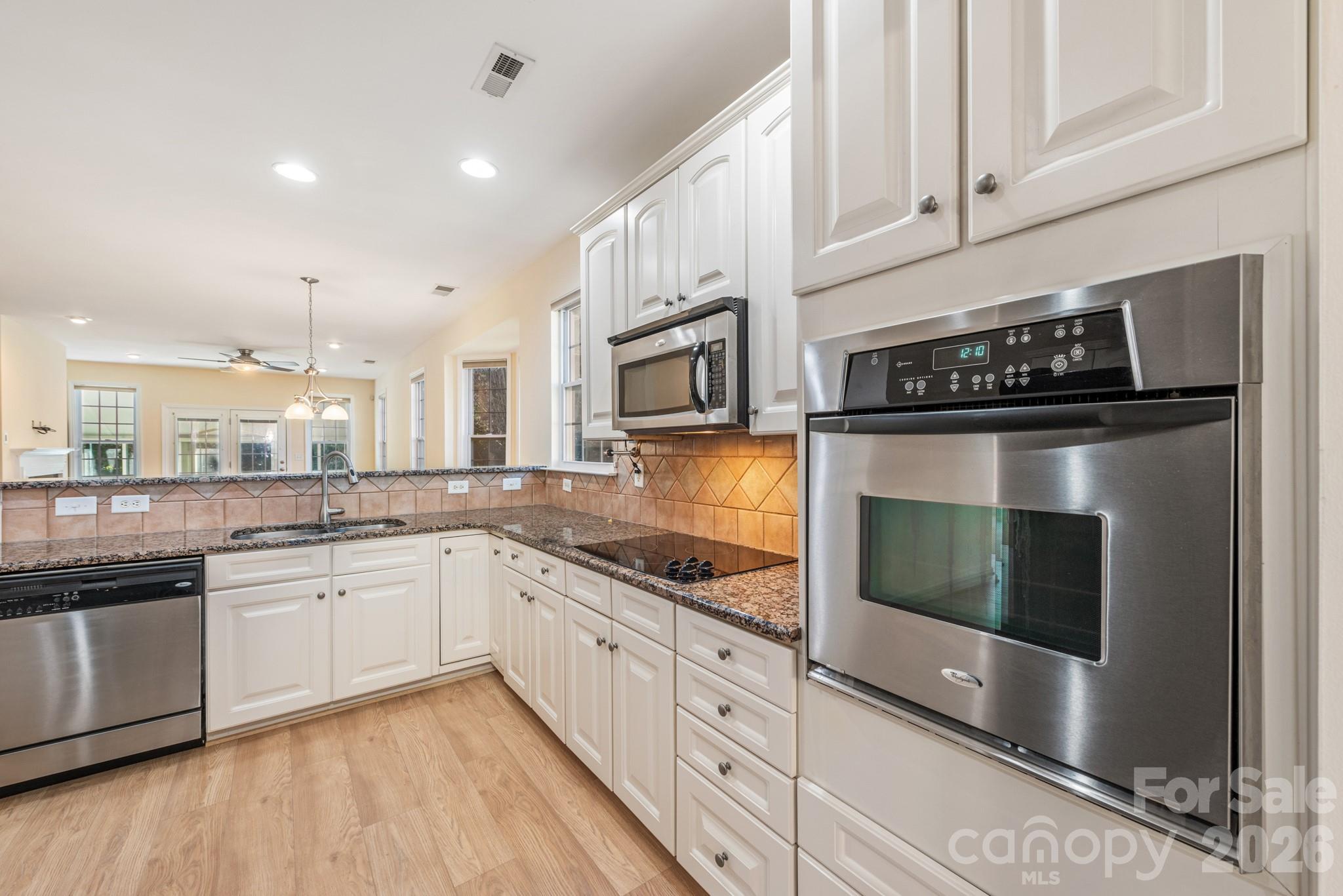 2013 Citron Avenue Fort Mill, SC 29708 - Photo 7 of 34 a kitchen with stainless steel appliances granite countertop a stove a sink and a microwave