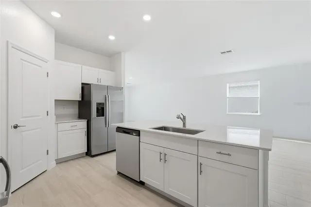 a kitchen with a sink and refrigerator