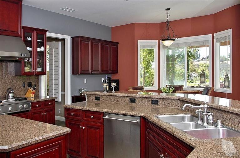 12428 Palmer Drive Moorpark, CA 93021 - Photo 11 of 42 a kitchen with stainless steel appliances granite countertop a sink a stove and a counter space