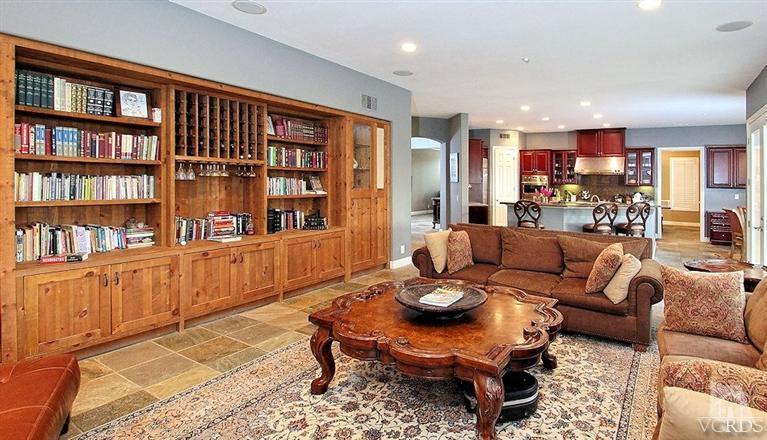 12428 Palmer Drive Moorpark, CA 93021 - Photo 13 of 42 a living room with furniture a rug and a book shelf