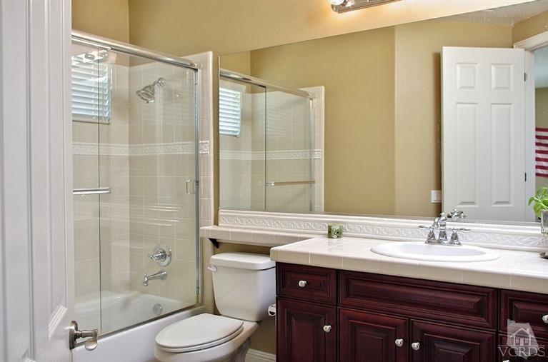 12428 Palmer Drive Moorpark, CA 93021 - Photo 17 of 42 a bathroom with a sink mirror toilet and shower