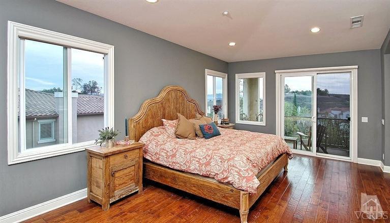 12428 Palmer Drive Moorpark, CA 93021 - Photo 21 of 42 a bedroom with a bed and large windows